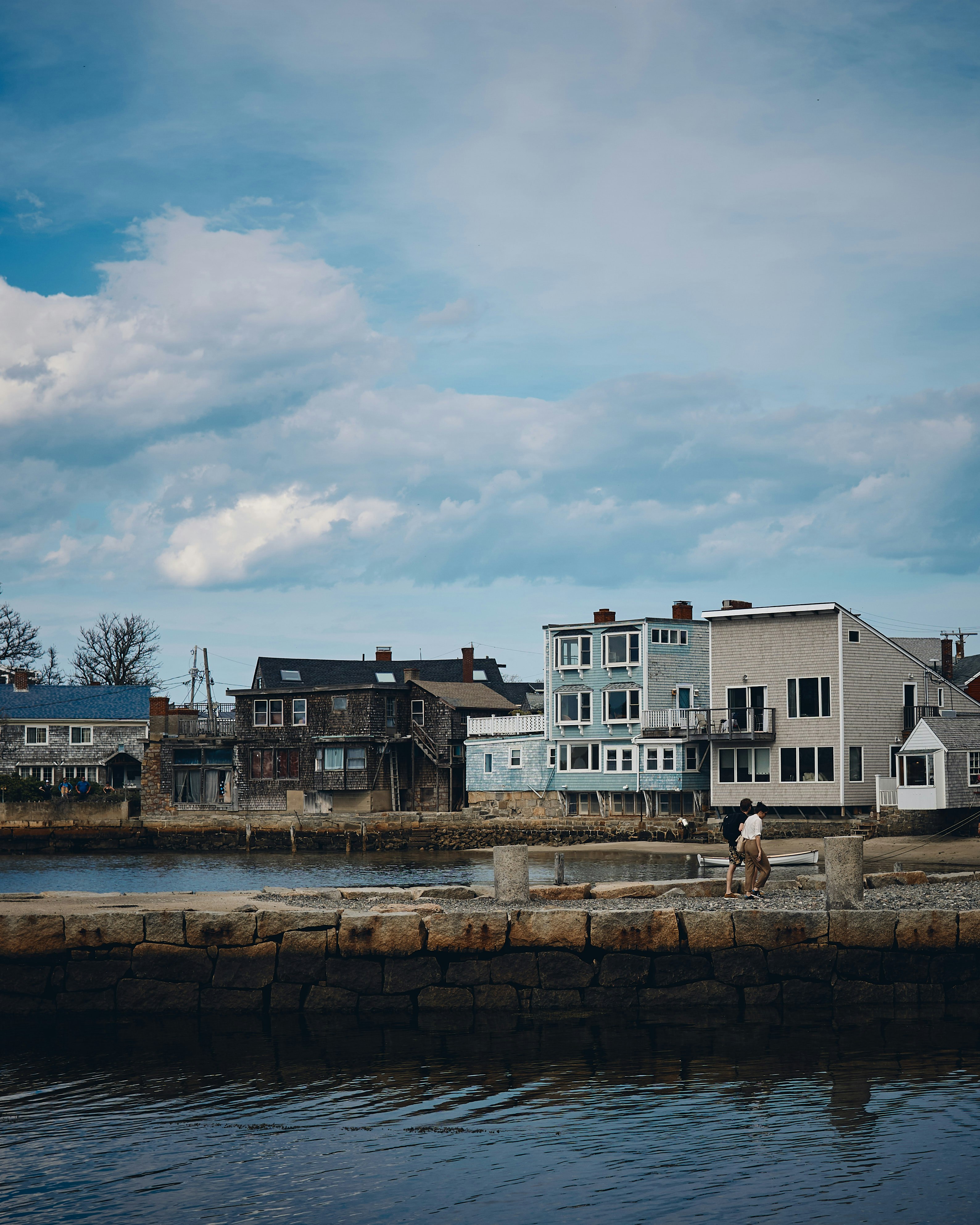 white and beige concrete building near body of water